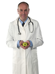 portrait view of a smiling doctor with apple.