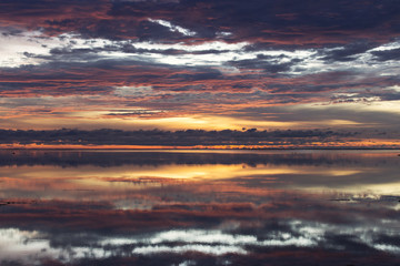 Fototapeta na wymiar Early morning, sunrise over sea with beautiful and colorful clou