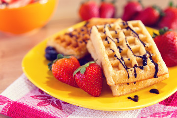 Waffles with chocolate topping and strawberries