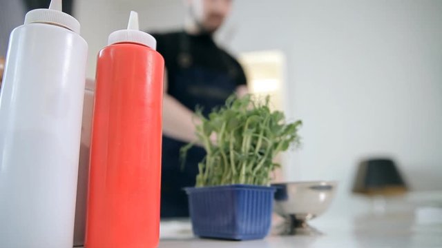 A chef is using ingredients to cook meals