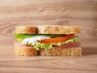 sandwich with smoked sausage, cheese, tomatoes and herbs