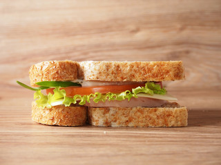 sandwich with ham, cheese, tomatoes and herbs