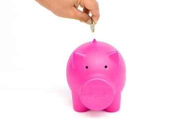 Money Saving Ideas.hand putting a coin into piggy bank.