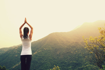 young fitness yoga woman at mountain peak