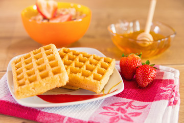 Waffles with honey and fresh strawberries