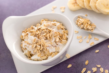 Oatmeal on purple wooden table.