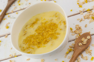 Oat meal in an assymetric white porcelain bowl.