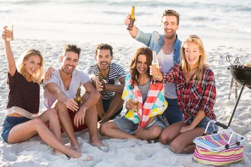 Friends drinking beer at the beach