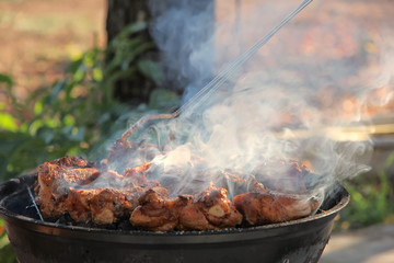 Meat on barbecue grill with smoke.