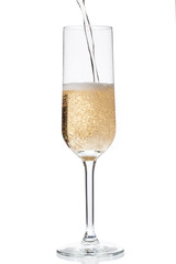 close-up image of champagne being poured into a champagne flute.