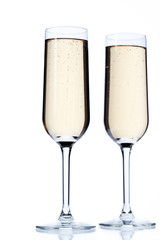 two champagne flutes full of champagne.