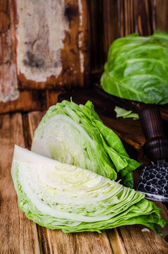 Slice of fresh cabbage on wooden background. Toned image. Selective focus