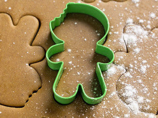 view of green cookie cutter on cookie dough.