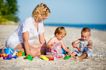 mother with two children on beach