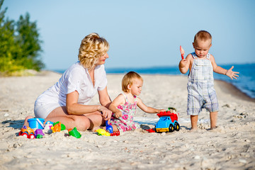 mother with two children on beach