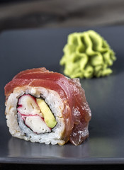 Sushi. Red Spider Roll served on grey plate with wasabi.