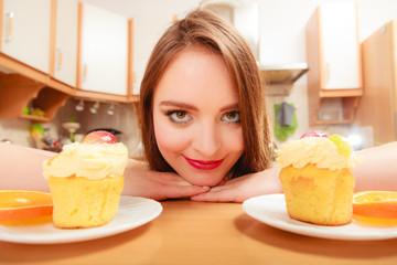 Woman looking at delicious sweet cake. Gluttony.