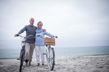Happy senior couple with their bike
