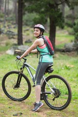 Fototapeta na wymiar Portrait of female biker in forest