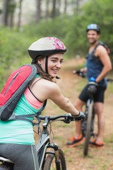 Happy female biker with man on dirt road