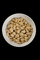 bowl of brown beans on dark background