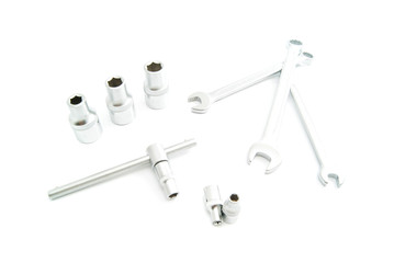 heads and different wrenches on white