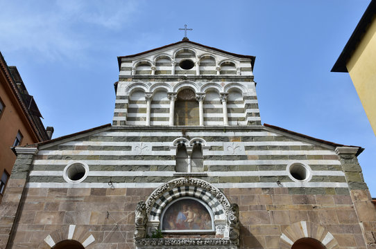San Giusto medieval church in Lucca. Detail of romanesque upper part of the facade with typical white and black stripes decoration and double loggia