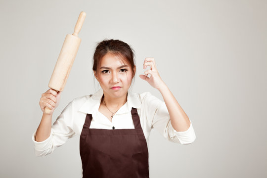 Asian Baker Woman  In Apron  With Wooden Rolling Pin