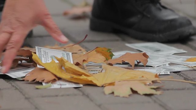 Street cleaner sweeping dollar banknotes in city street, money losing value