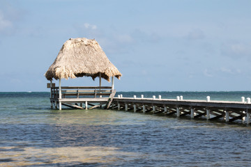 Pier in Belize with palm thatched roof