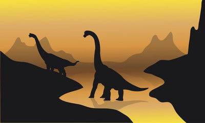 Silhouette of brachiosaurus in river