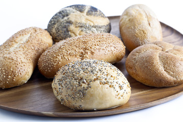 a wooden plate with plenty of baked bread