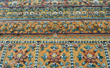 Colorful aged flower ceramic tile decoration at buddhist temple