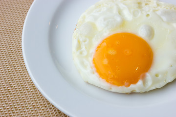 Fried egg on a white dish