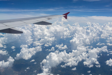 Obraz premium Above the clouds.Wing aircraft in the sky under earth of Bali,Indonesia