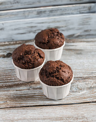 Chocolate muffins on a blue wooden background