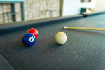 Closeup of billiard balls - red, blue and white.