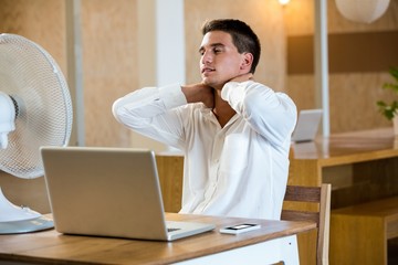 Man enjoying a breeze while using laptop