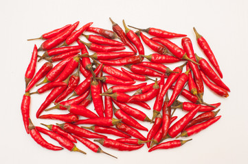Many red hot chili peppers on white background
