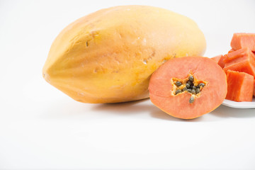Fresh papaya slice with papaya on dish isolated.Center.right