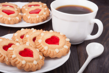 cookie with heart  jelly cup of coffee on  wooden table