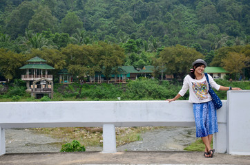 Fototapeta na wymiar Thai woman smiling and portraiton bridge of Ban Khiri Wong villa
