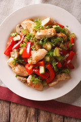 Chicken breast fried with mushrooms, peppers and zucchini closeup. vertical top view
