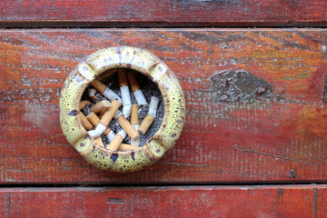 Cigarette, Smoking, Pollution, Smoking, Danger. Ashtray with stub on the table with top view