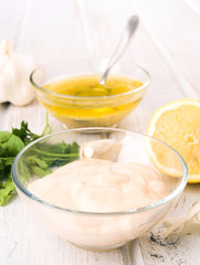 pink sauce and vinaigrette dressing in glass bowl