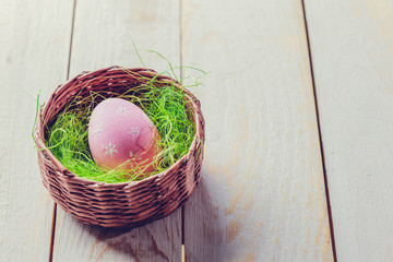 Easter eggs painted in pastel colors on white wooden background.