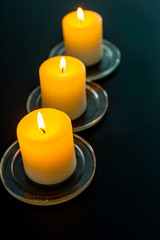 closeup to burning candles in darkness