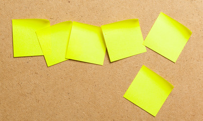 Color sticker notes over cork board background