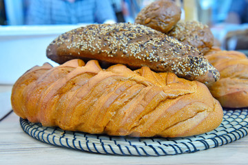Loaf of white and brown bread on a white pedestal