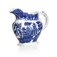 Blue Willow pattern jug on white background with soft shadow at base. Made in England in the 1930s by Allertons. Focus stack, in focus front to back.